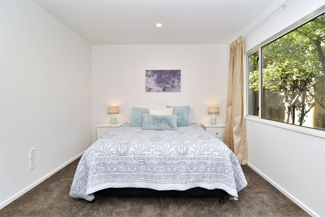 Bedroom 3, downstairs, features a Queen-sized bed