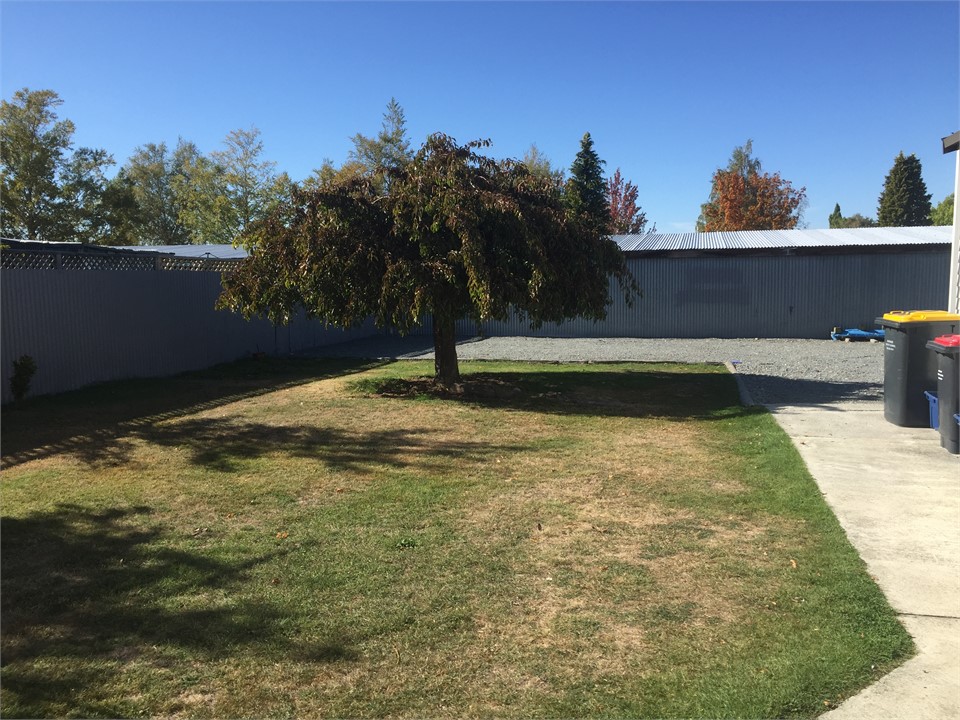 Large fenced off garen with off street parking