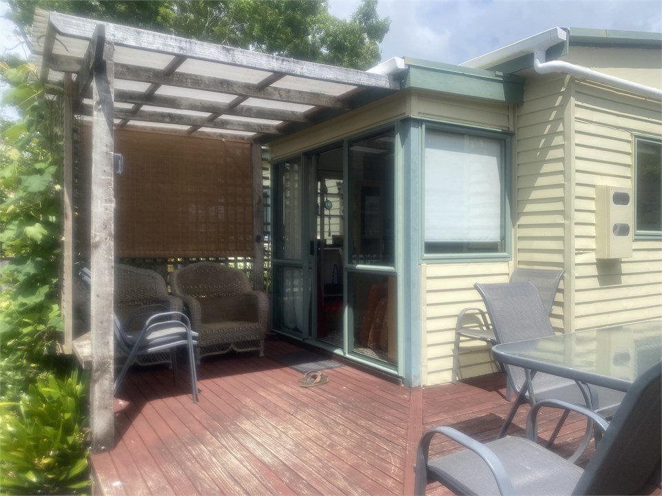 Shaded porch area front of cottage