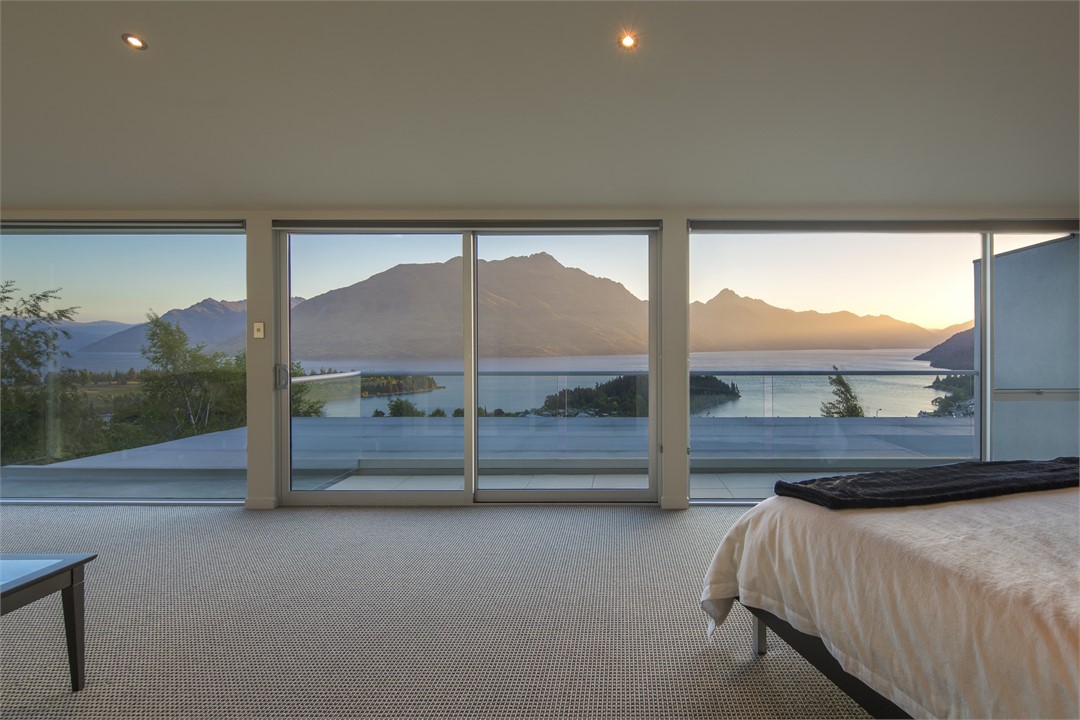 Panoramic lake and mountain views from bed