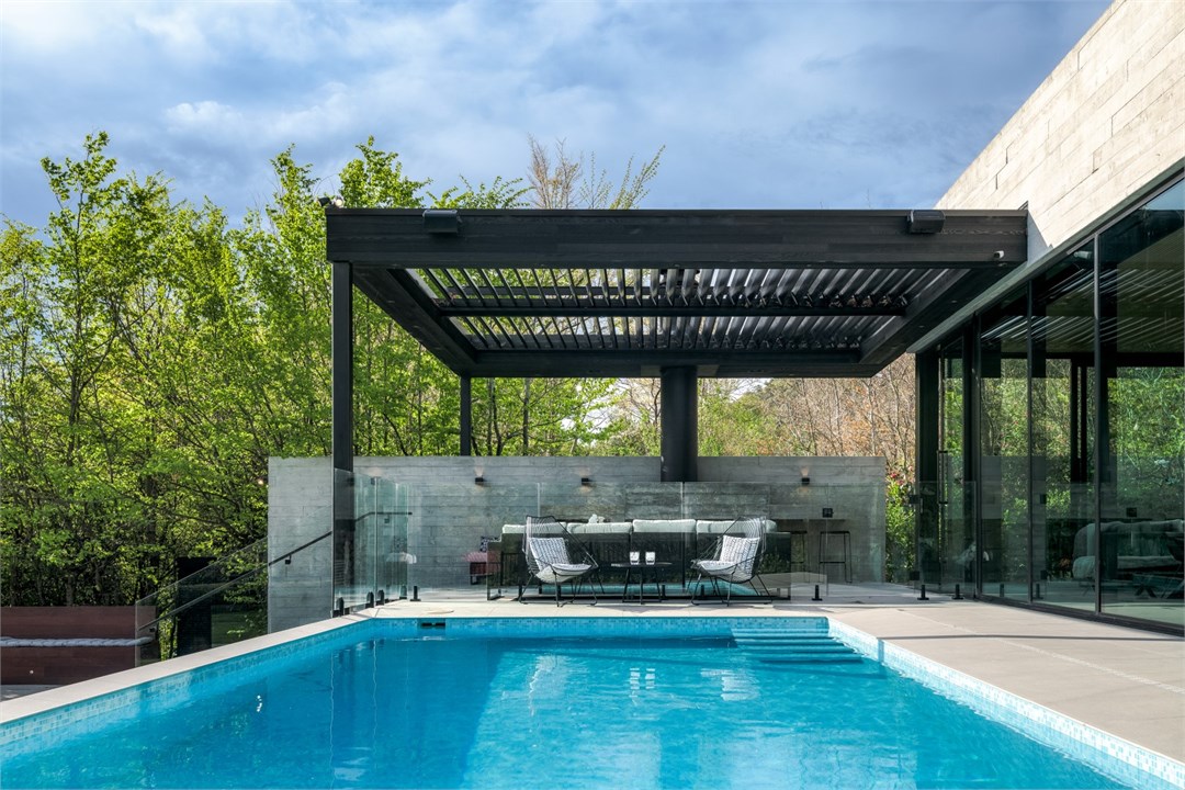 View of the pool and seating areas by the fireplac