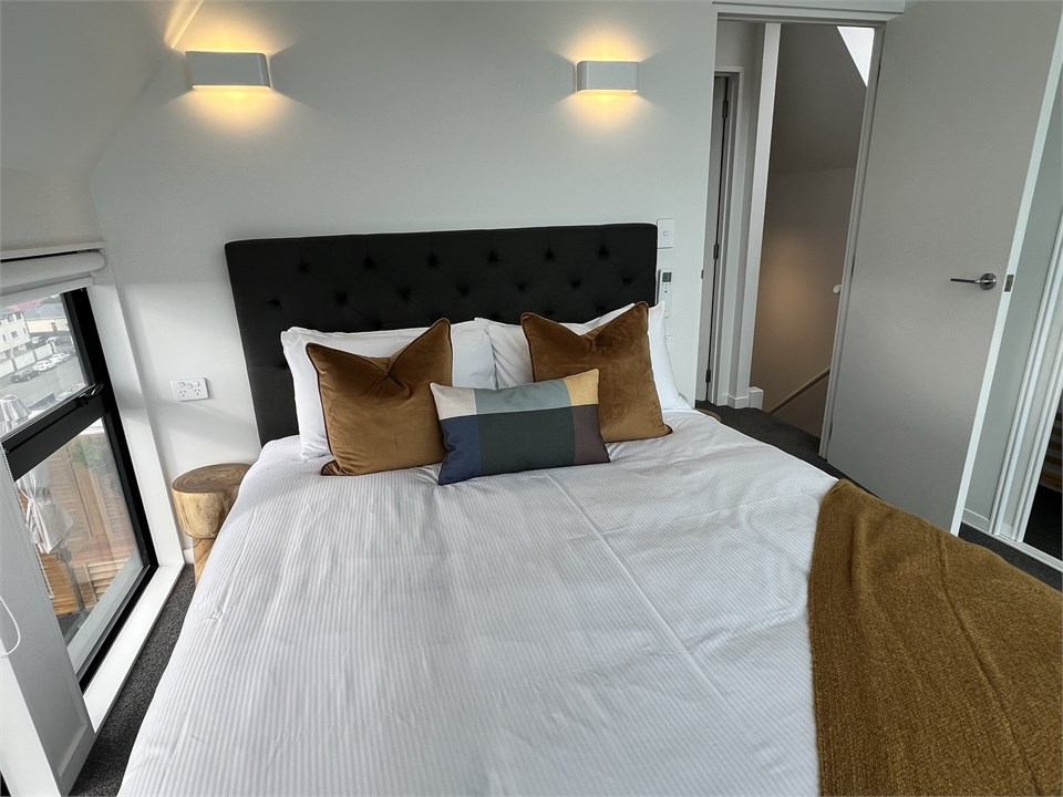 Master bedroom has a Queen bed with a view