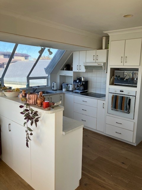 Kitchen next to dinning room looking out to the oc