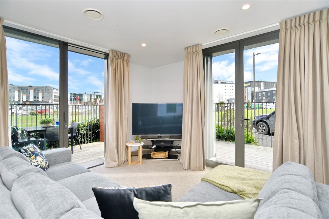 Living room has seating areas and a TV