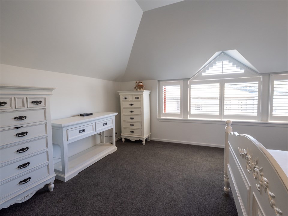 Crisp white master bedroom with painted furniture