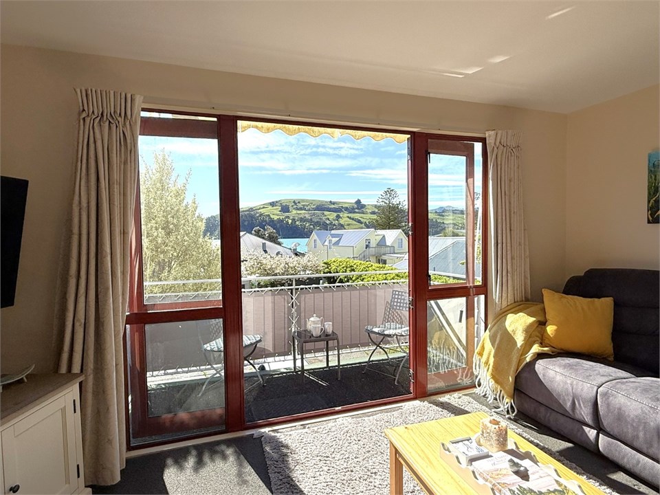 Living room has a TV and seating areas