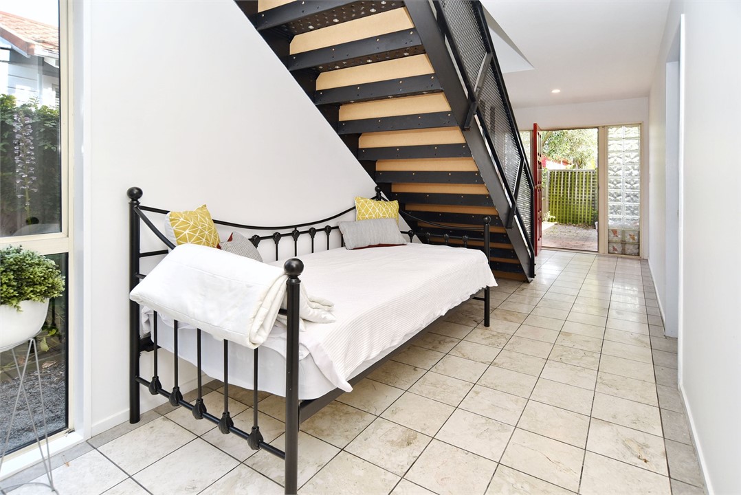 There is a day-bed under the stairs available