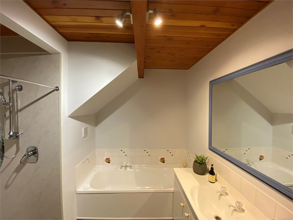 Bathroom 1 has a shower, bath and a toilet