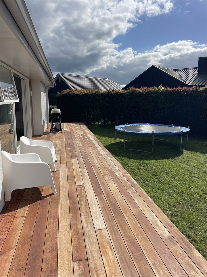 Private, sun soaked backyard with trampoline.