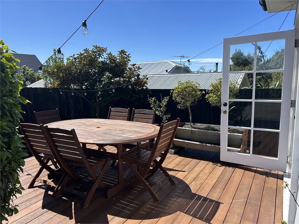 Sun-filled outdoor deck with Weber BBQ