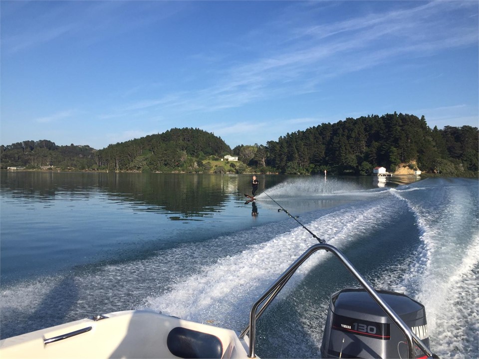 waterskiing in front of the house in the channel