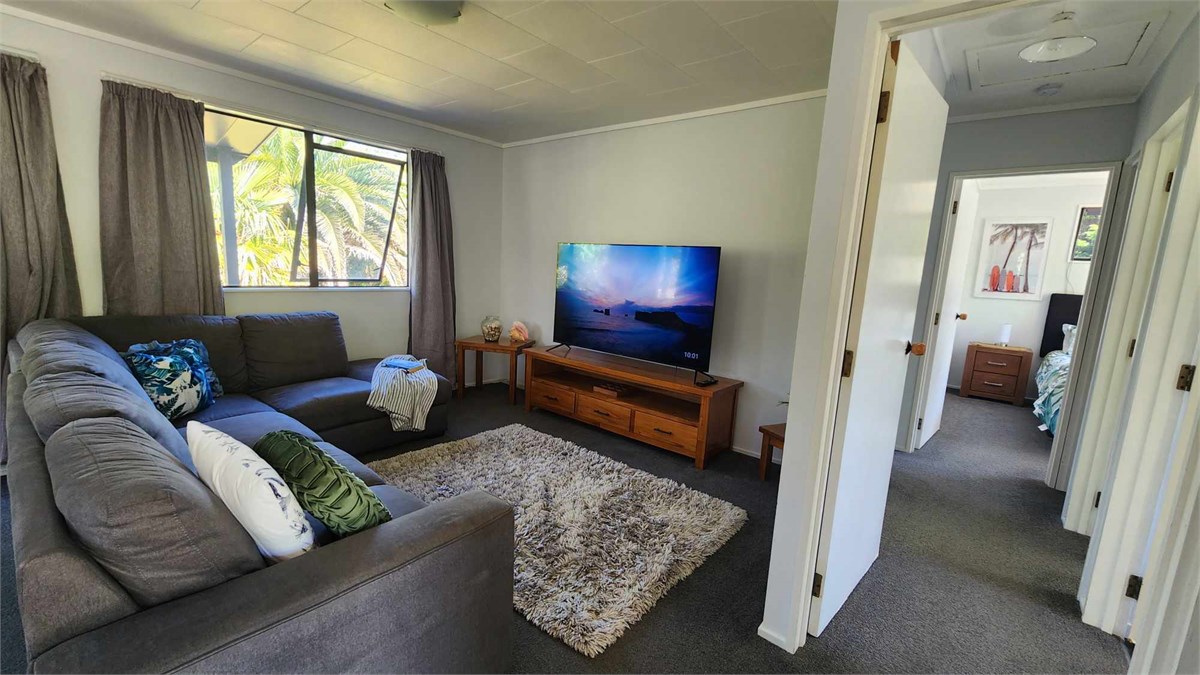 Lounge area seats five with a 65inch smart TV. Bot