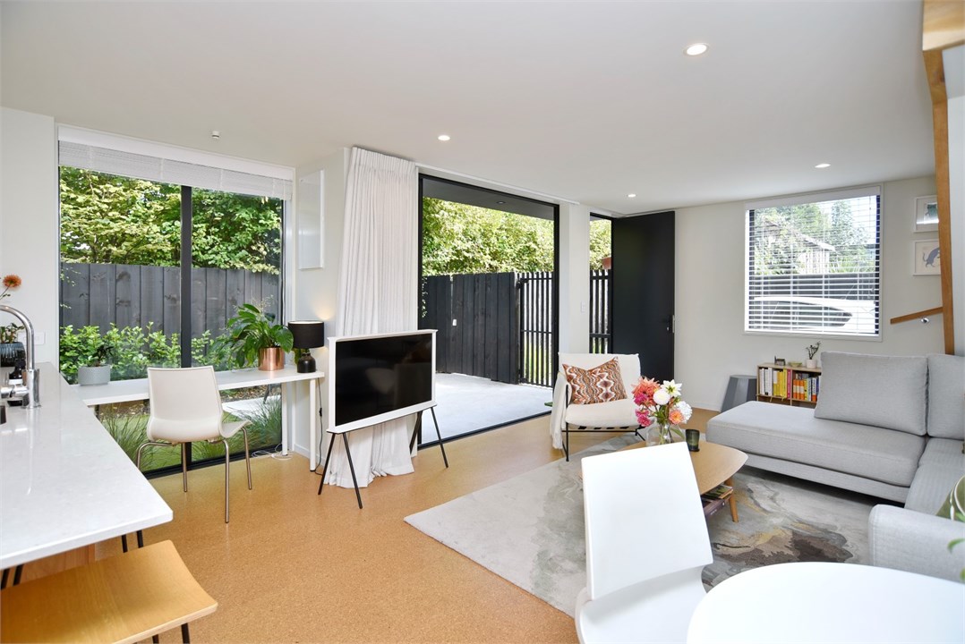 Living room with seating areas and a TV