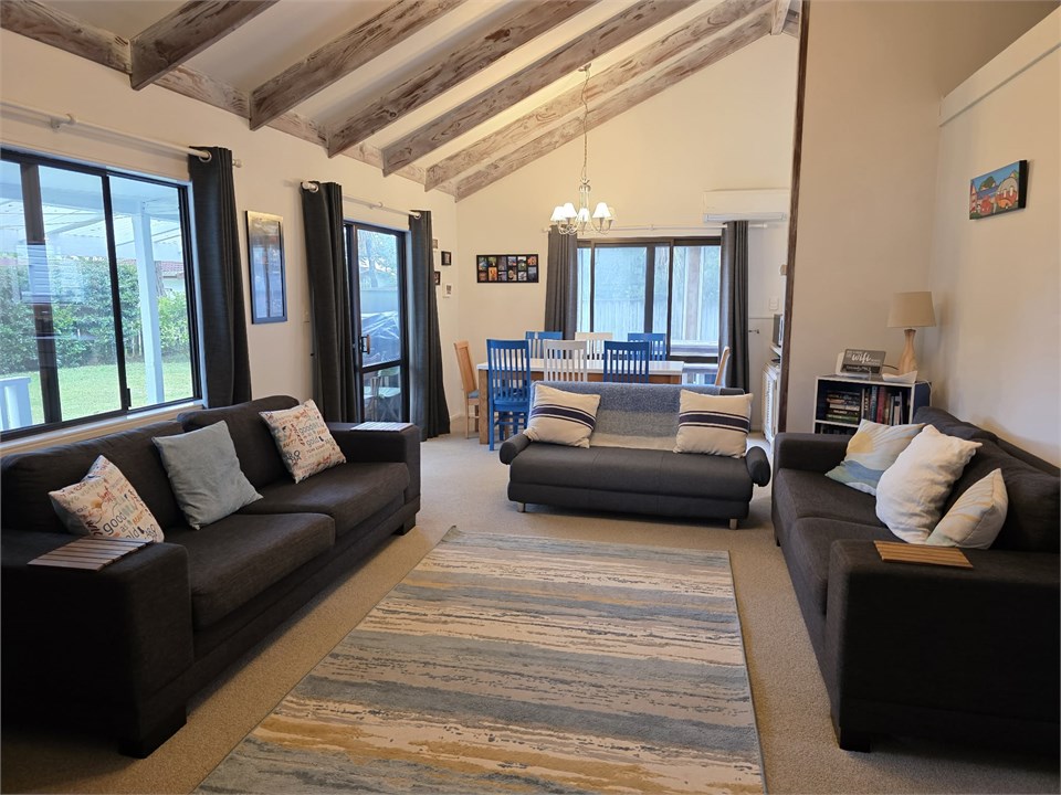 Living room with dining room in background