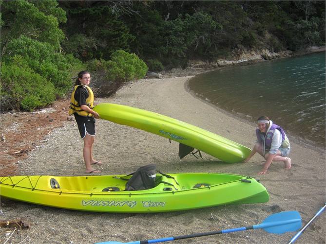 Kids on beach with kayaks