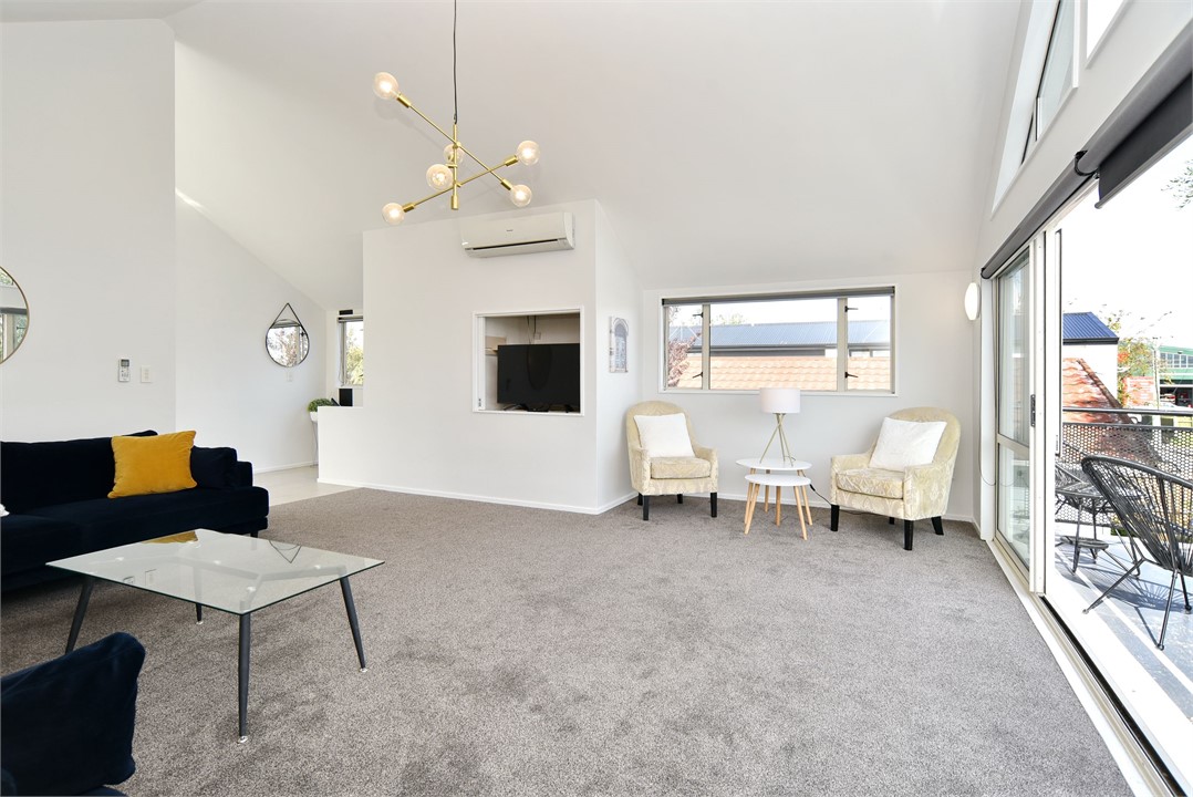 The living room includes multiple seating areas