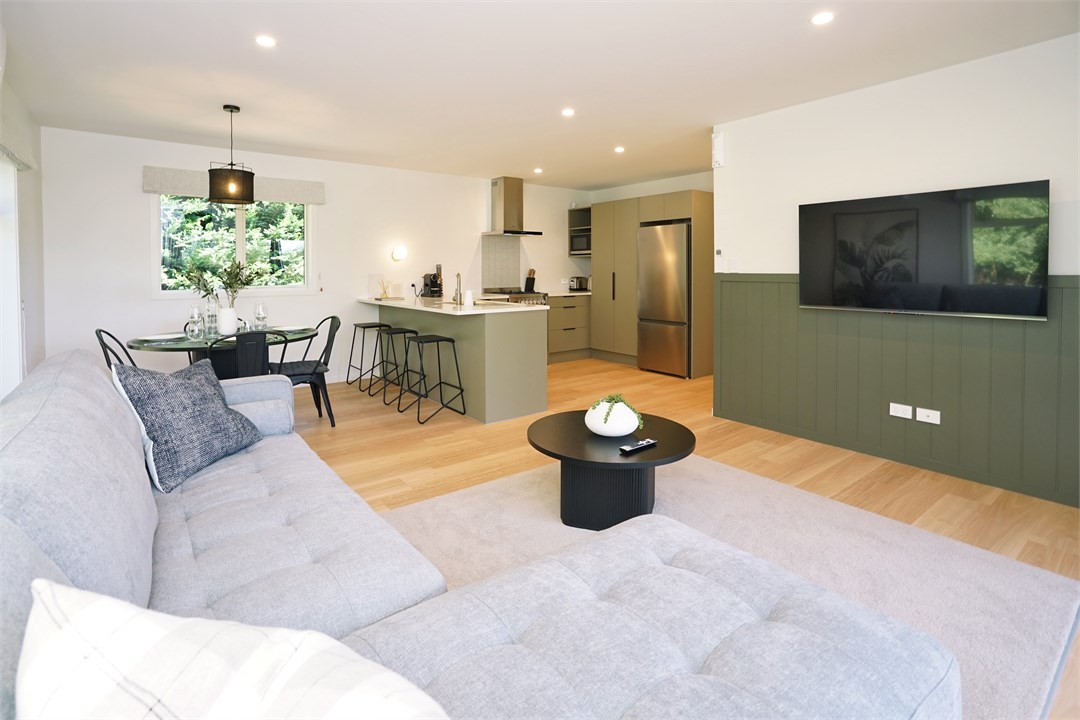 Living room has a TV and seating areas