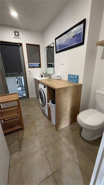 Laundry with shower and toilet