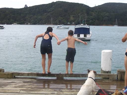 Kids jumping off wharf at schoolhouse bay
