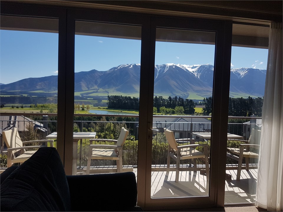 View across private deck over golf course to Mount