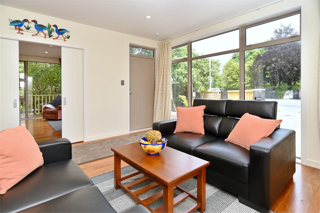 An open-plan living room flows between kitchen, di