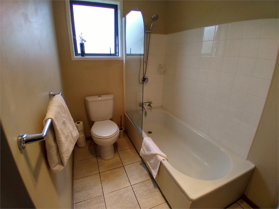 Full bathroom off living area - Bath over shower