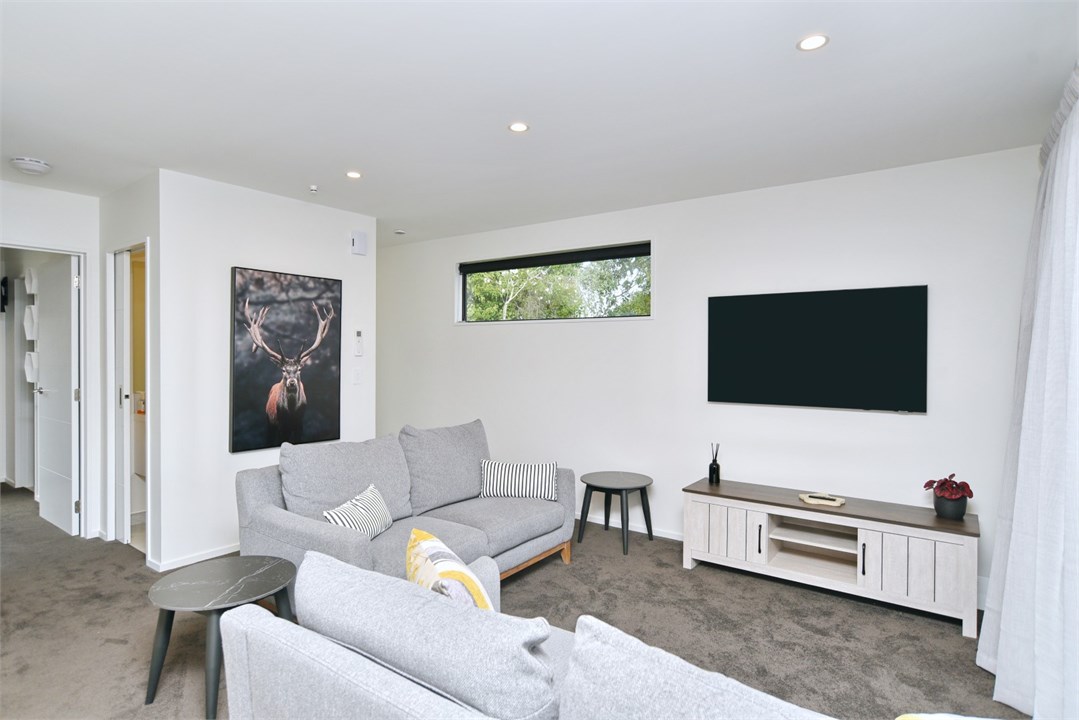 Living room has a TV and seating areas