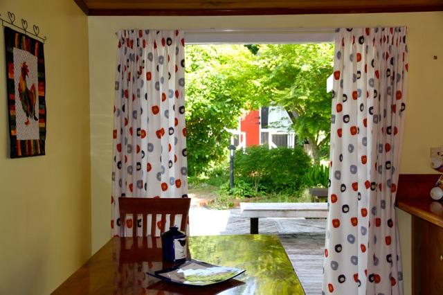 Sunny modern kitchen leads onto sheltered deck