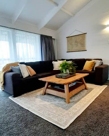 Living area with comfortable sofa and large wall m