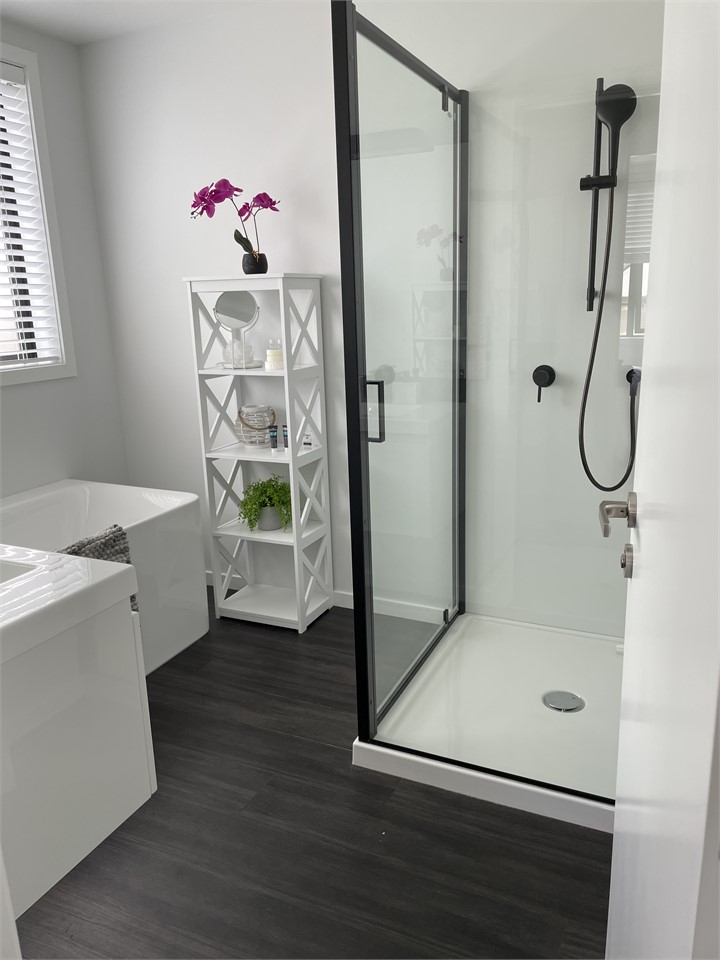 Main bathroom with large shower and bath.