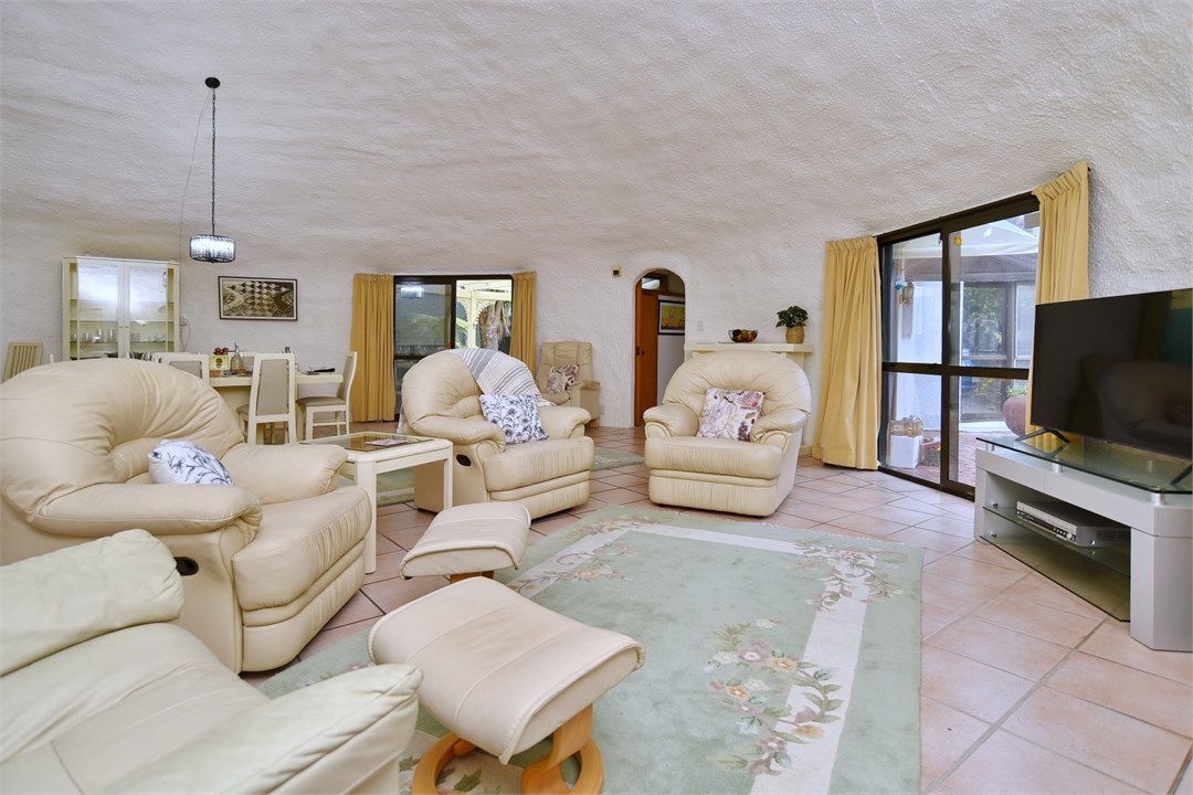 Living room with seating areas and a TV