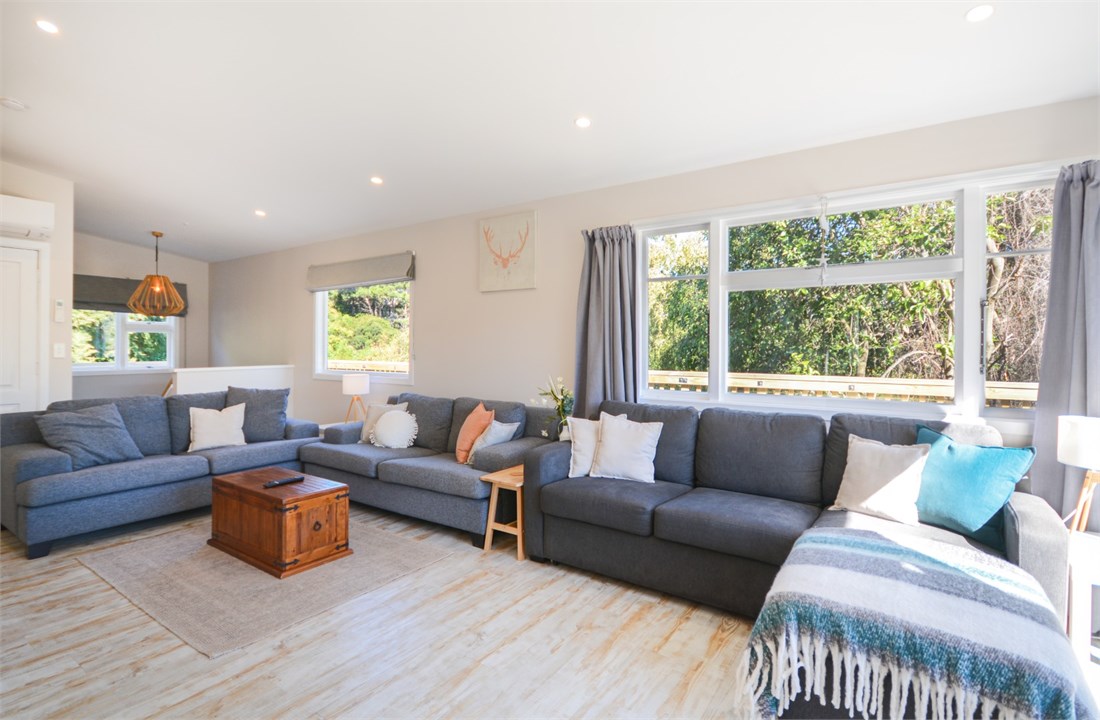 Living room has a TV and seating areas