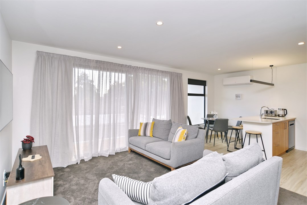 Living room has a TV and seating areas