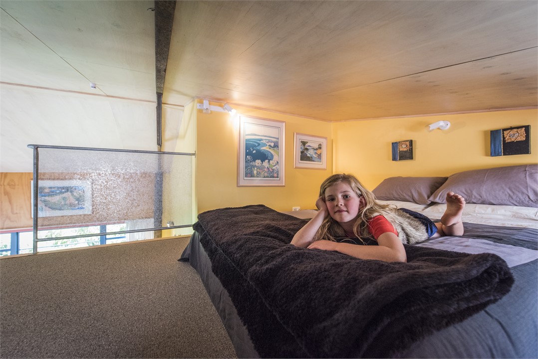 Mezzanine low-ceiling queen loft with ladder