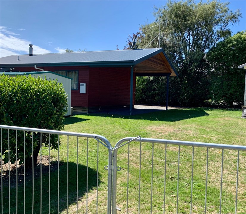 Rear grassy lawn with side gate entry