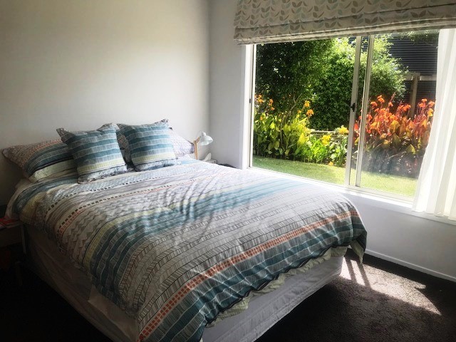 Main bedroom Queen size bed, view to canna lilies
