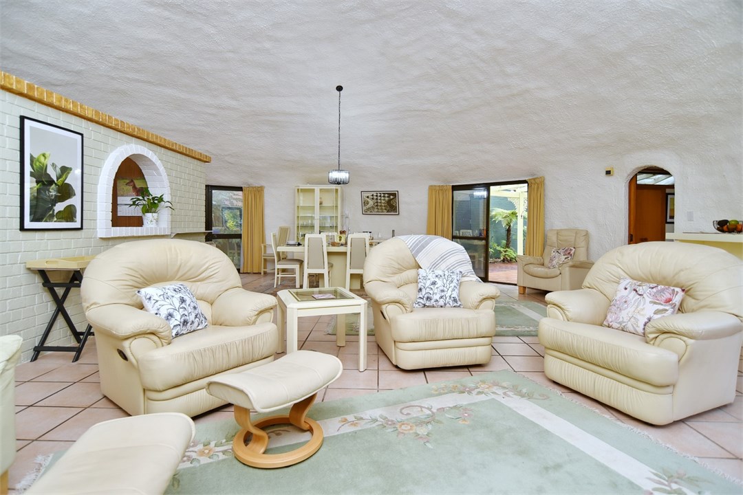 Living room with seating areas and a TV