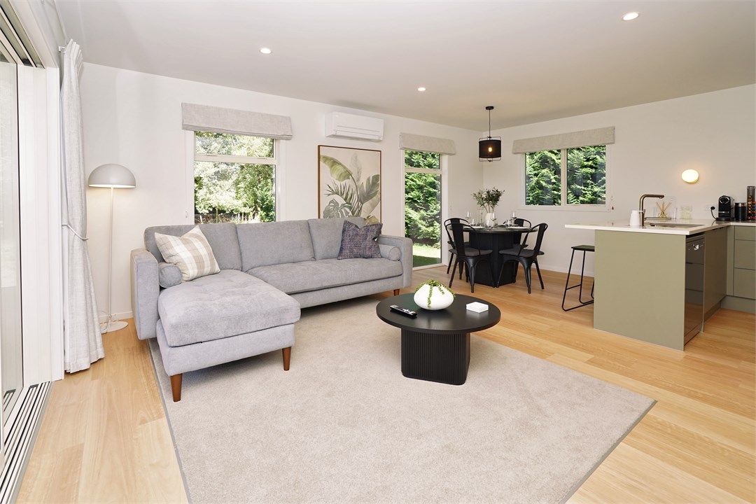 Living room has a TV and seating areas