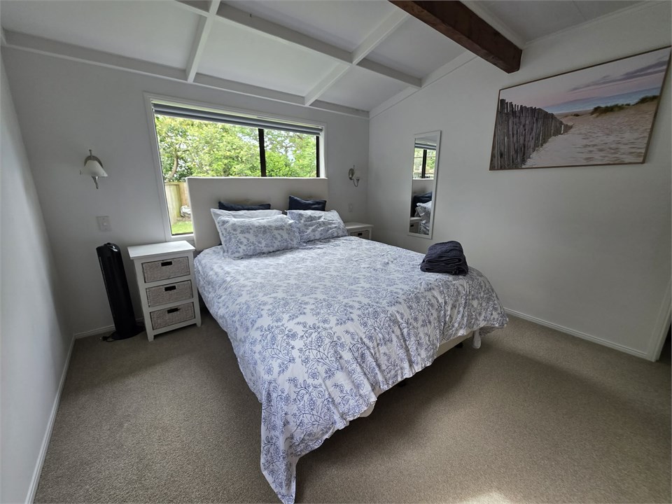 Adult room with queen bed and room for a portacot 