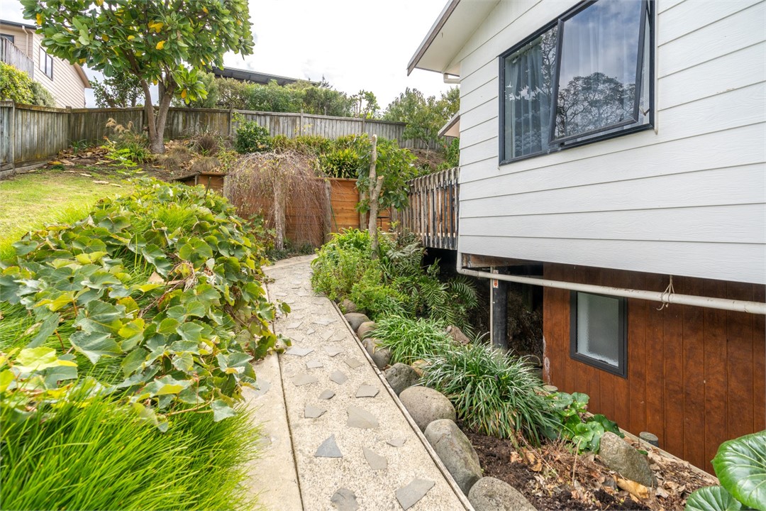 Back garden walkway and view of the property