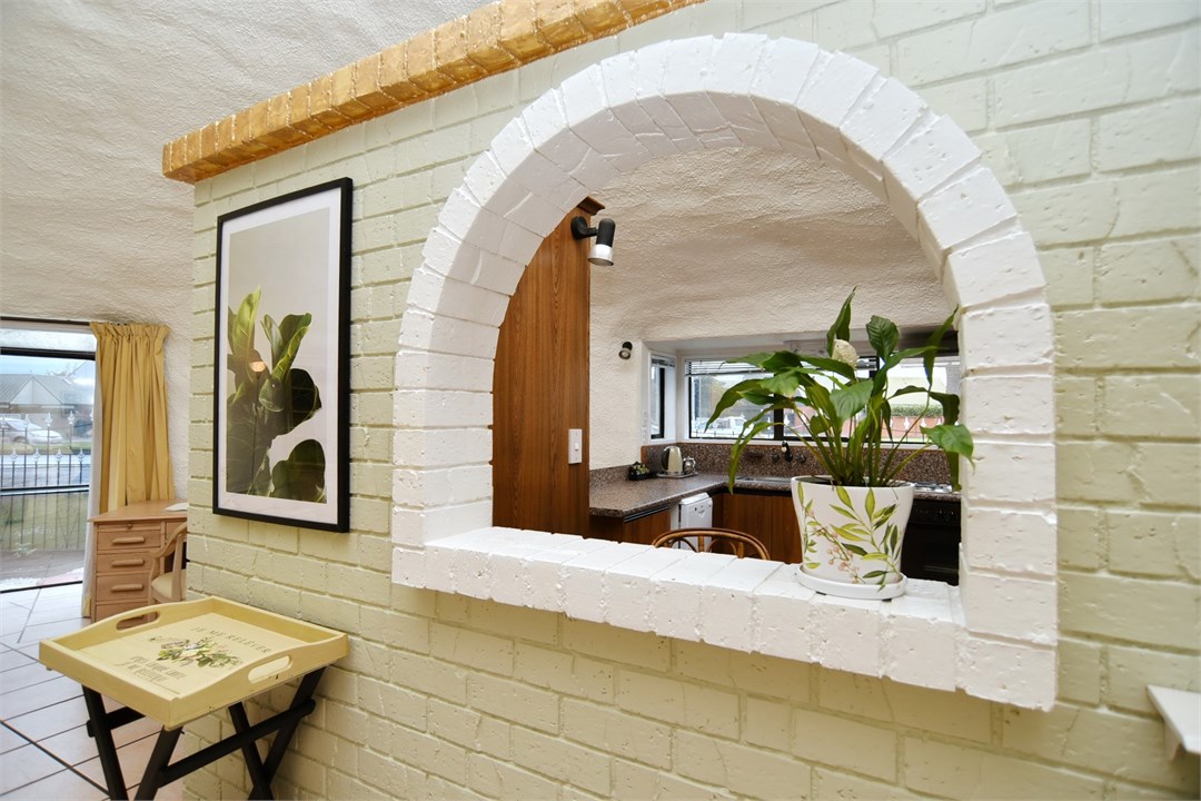 Living room area and window looking into the kitch