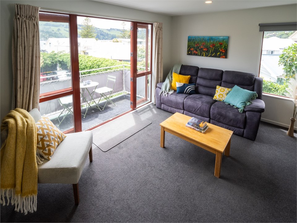 Living room has a TV and seating areas
