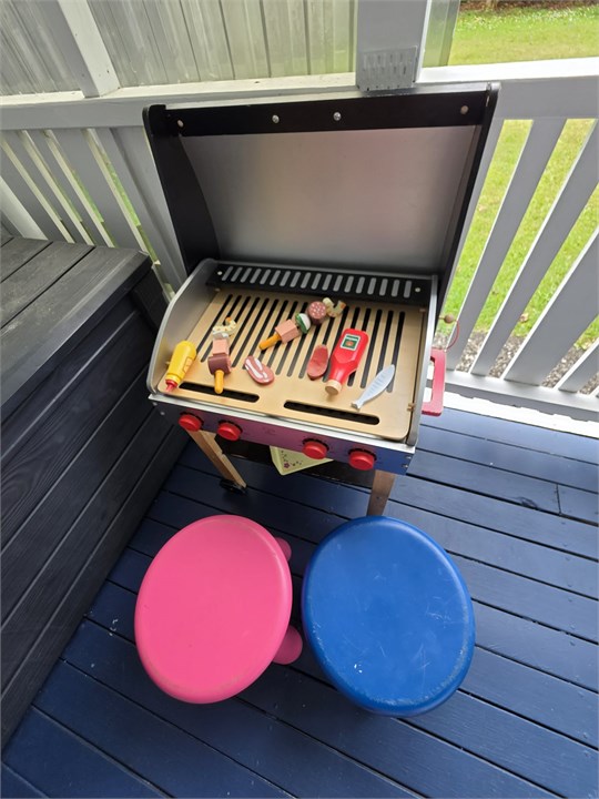 Kids toy BBQ and chairs near the sand toy box