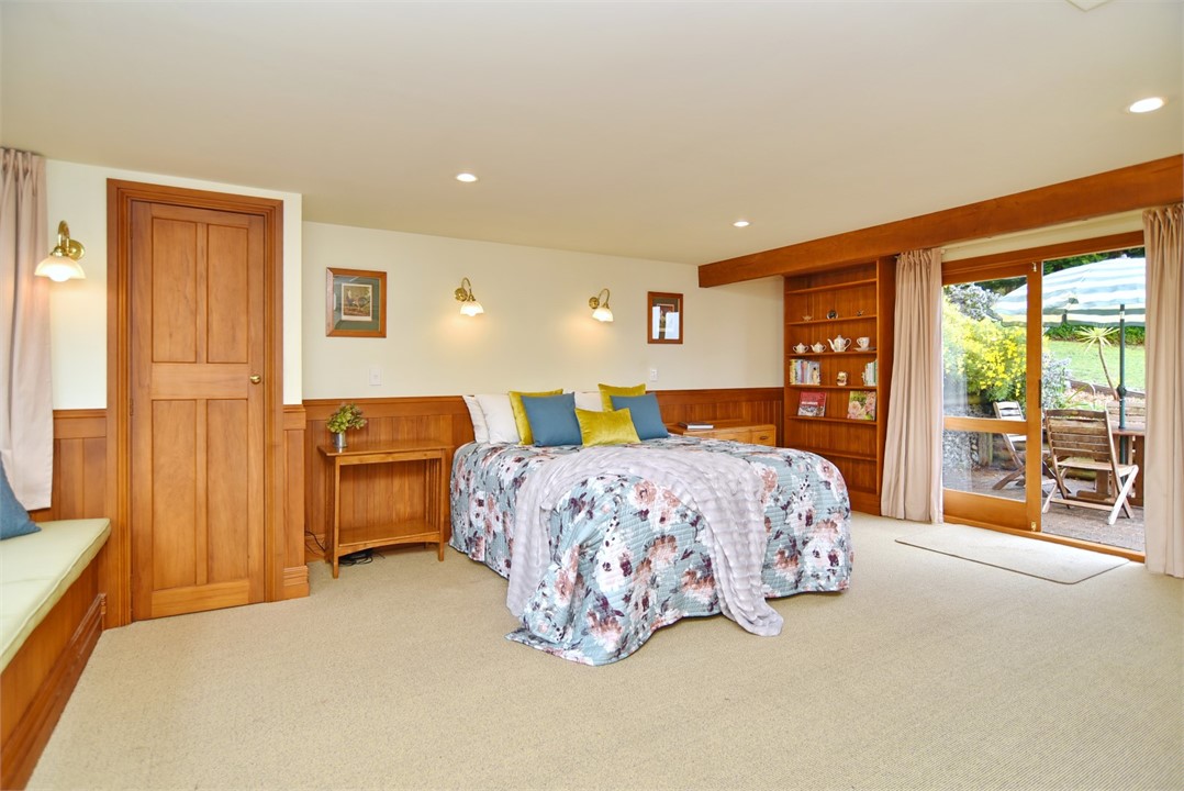 The bedroom has a Queen bed and seating areas