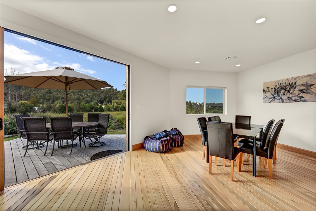 Dining room looking onto deck with wetlands and bi