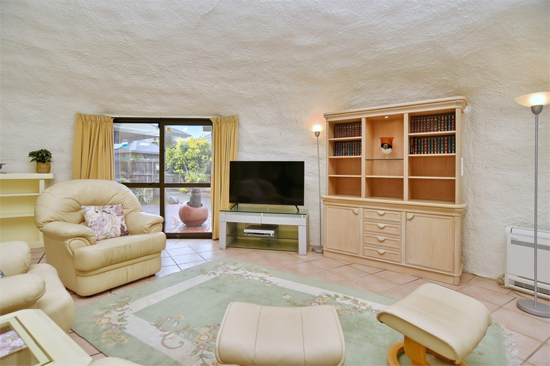 Living room with seating areas and a TV