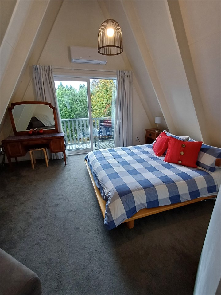 Upstairs bedroom 1 with queen bed. Opens onto priv