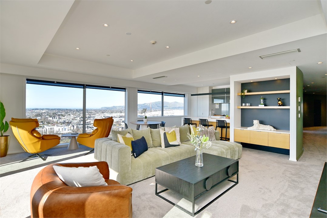 Living room has a TV and multiple seating areas