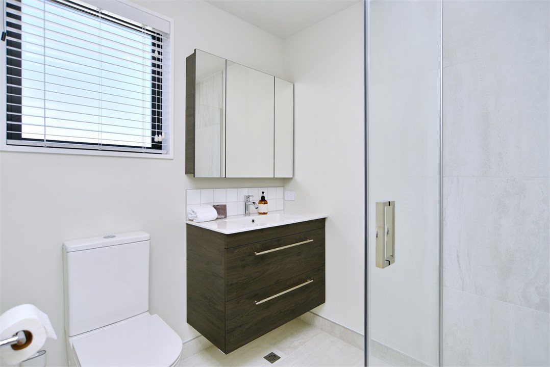 Bathroom 1 has a shower and a toilet