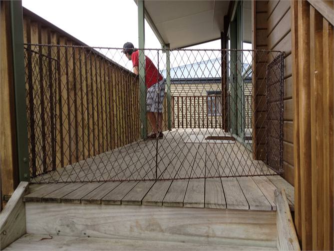 Kiddy Gaurd at top of stairs looking up staris